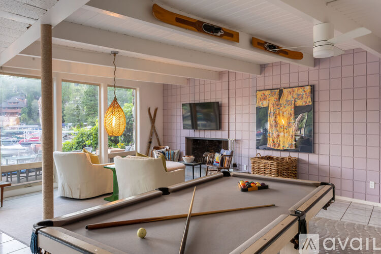 A room with a pool table and a fireplace.