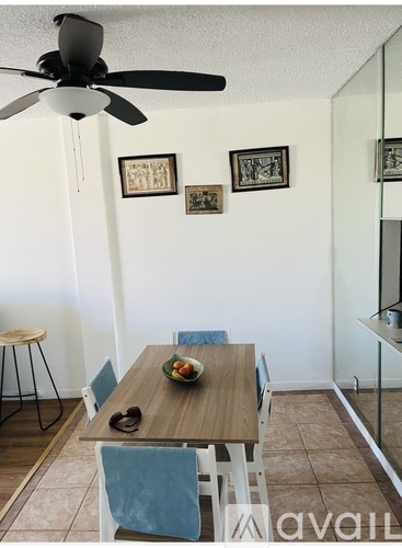 A dining room with a wooden table and chairs.