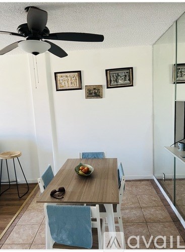 A dining room with a wooden table and chairs.
