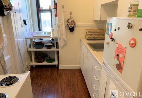 A small kitchen with a white fridge and a white stove.