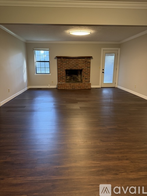 A room with a fireplace and a door.