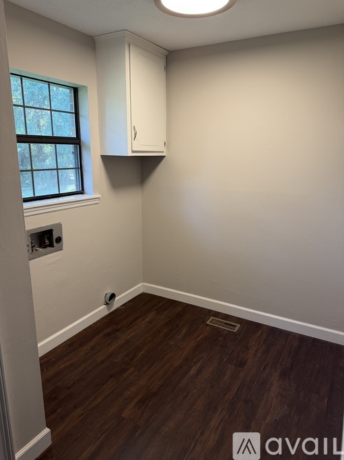 A room with wooden floors and a window.