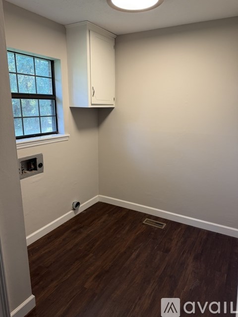 A room with wooden floors and a window.