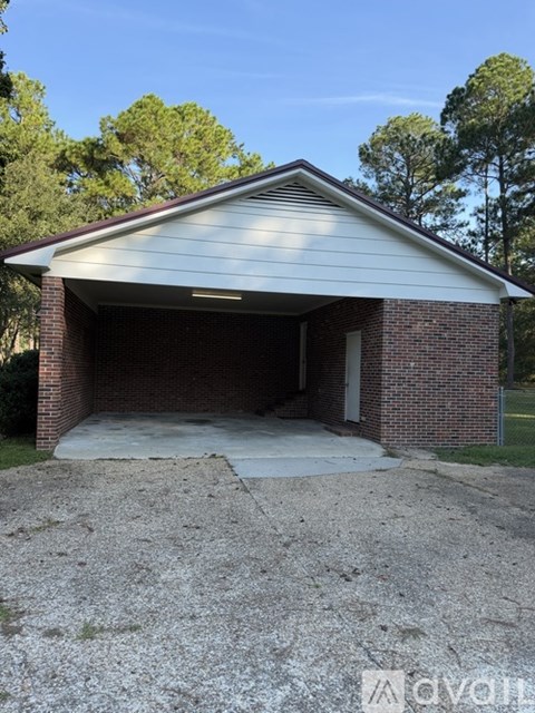 A garage with a brick wall and a metal roof.