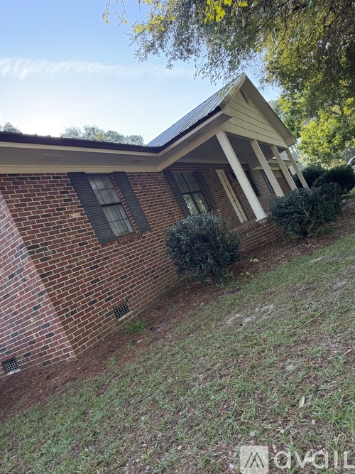 A house with a brick exterior and a gutter on the roof.