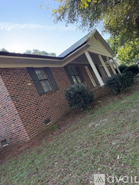 A house with a brick exterior and a gutter on the roof.