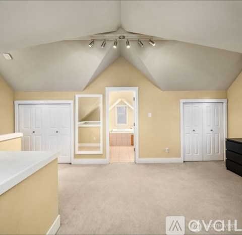 A spacious room with a carpeted floor and a white countertop.
