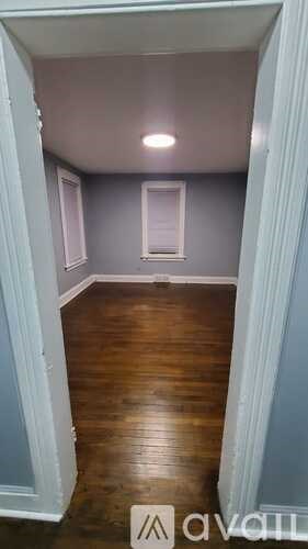 A room with a wooden floor and a window.