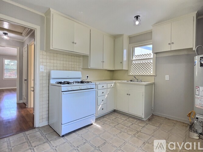 A kitchen with a white dishwasher and a white stove top oven.
