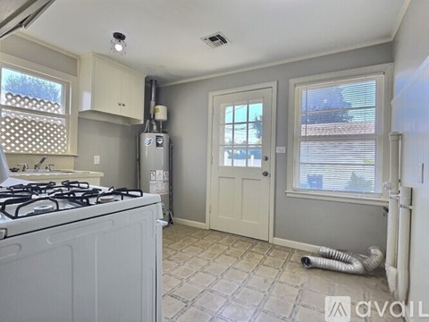A kitchen with a white stove top oven and a white fridge.