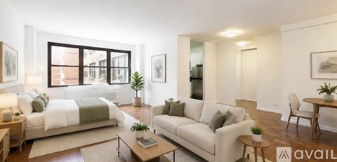 A living room with a white couch and a coffee table.