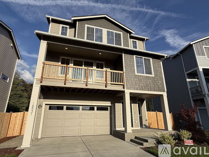 A modern two-story house with a garage is available for sale.