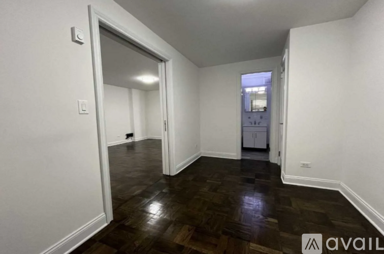 A room with white walls and a wooden floor.