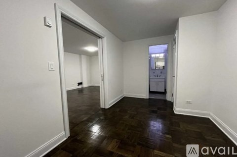A room with white walls and a wooden floor.