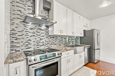 A kitchen with a stove top oven and a microwave above it.