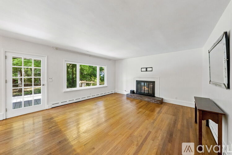 A living room with a fireplace and a television.