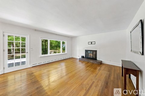 A living room with a fireplace and a television.