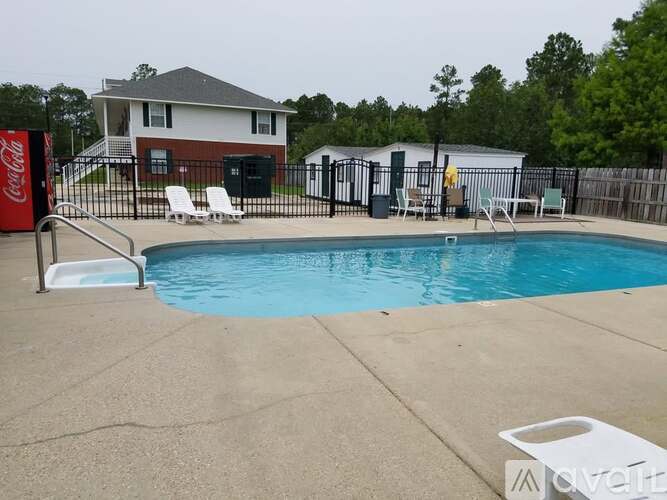 A Coca-Cola sign is on the left of a pool.