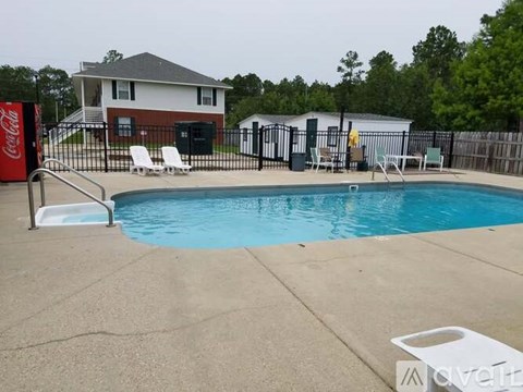 A Coca-Cola sign is on the left of a pool.