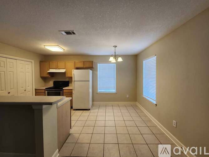 A kitchen with white appliances and a white counter top.
