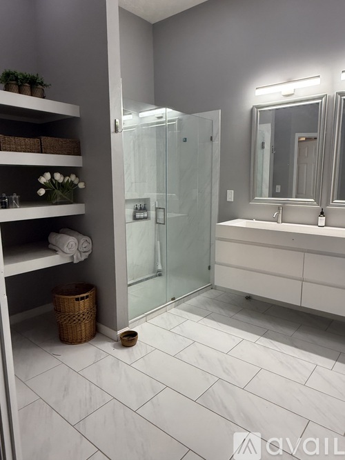 A bathroom with a white tiled floor and a white sink vanity.