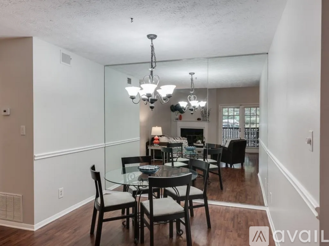 A dining room with a glass table and chairs.