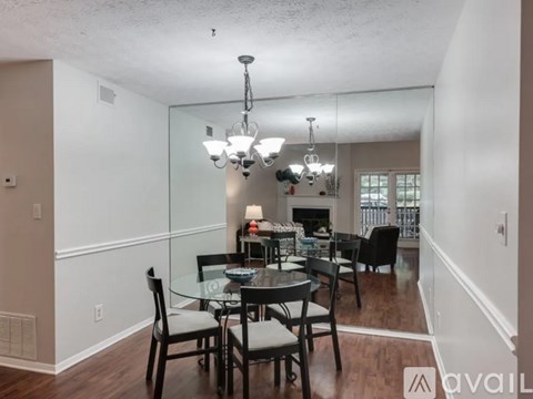 A dining room with a glass table and chairs.
