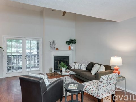 A living room with a couch, chair, and a fireplace.