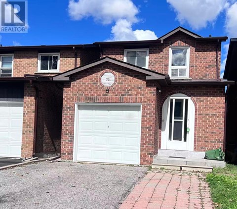 A red brick house with a white garage door and a white door.