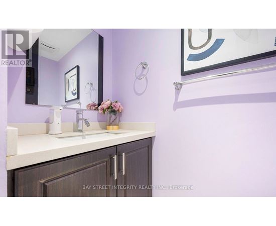 A bathroom with purple walls and a white countertop.