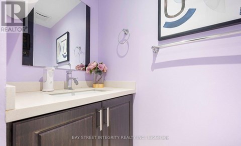 A bathroom with purple walls and a white countertop.
