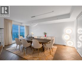 A dining room with a table set for four and a view of the city.