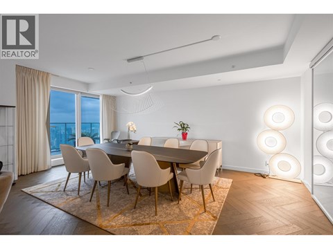 A dining room with a table set for four and a view of the city.
