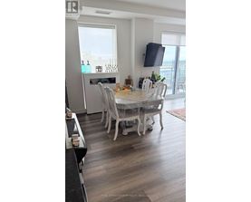 A dining room with a table set for six people.