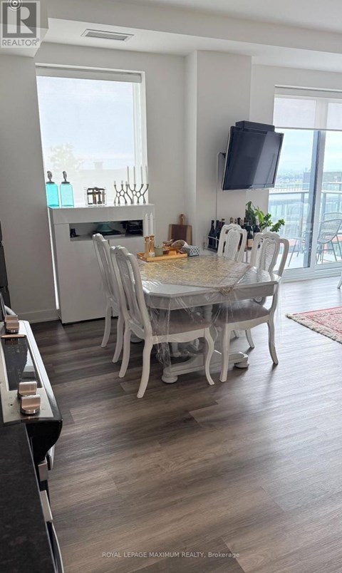 A dining room with a table set for six people.