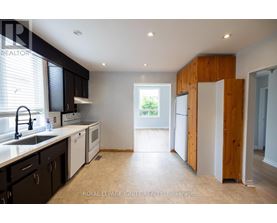 A kitchen with black cabinets and a sink.