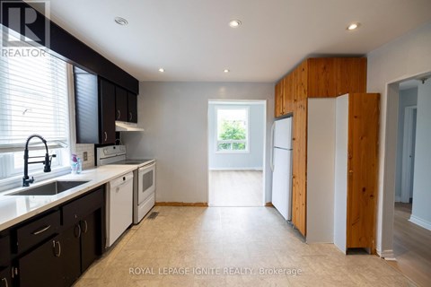 A kitchen with black cabinets and a sink.