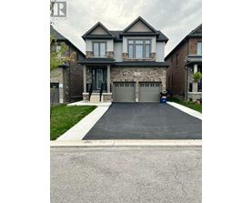 A large house with a grey garage door.