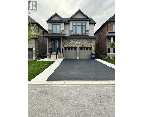 A large house with a grey garage door.