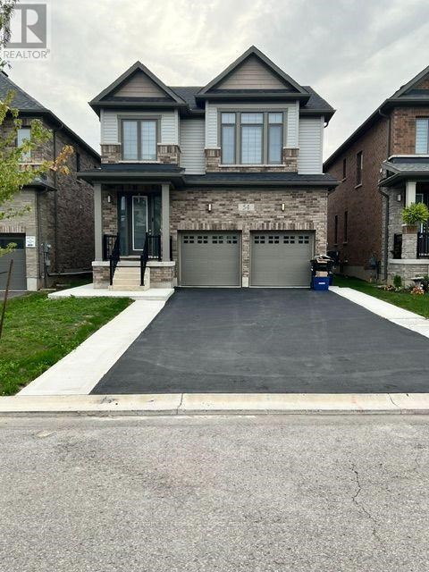 A large house with a grey garage door.