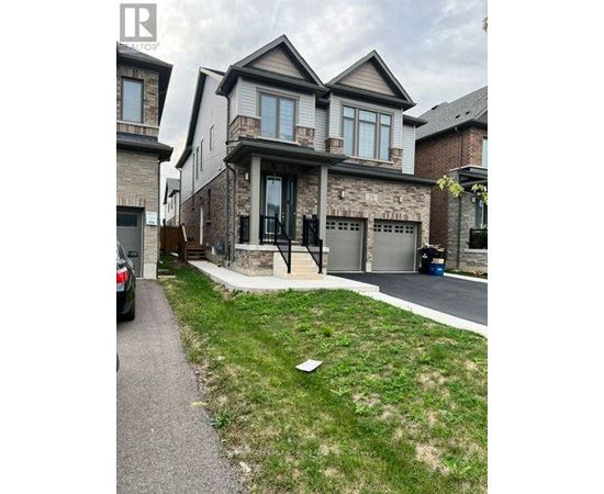 A house with a grey garage door is in front of a house with a brown garage door.