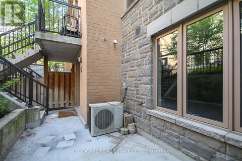 A stone building with a balcony and a window.