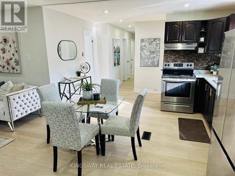 A modern kitchen with a dining table and chairs.