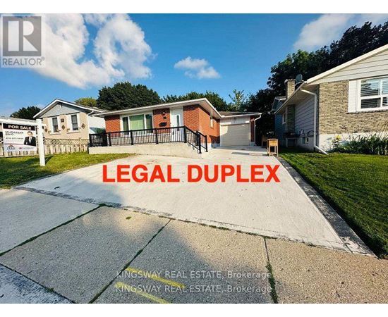 A real estate sign in front of a house with the words "LEGAL DUPLEX" written on it.