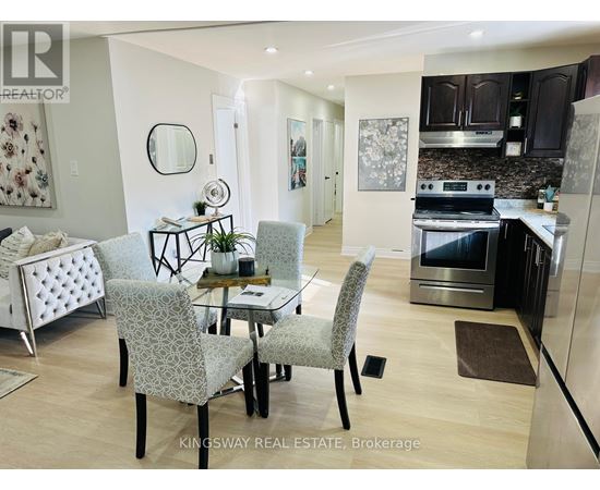 A modern kitchen with a dining table and chairs.