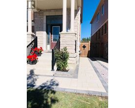 A house with a red door and a small garden in front.