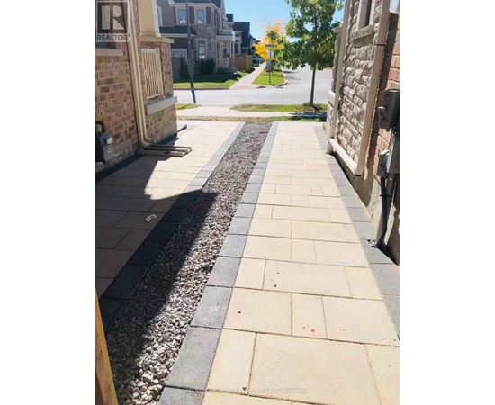 A sidewalk with a gravel strip in the middle.