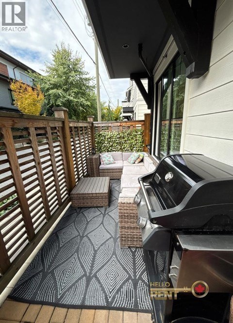 A black grill with the words "Hello Pant" on it is on a patio with a patterned rug.