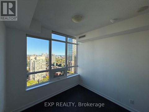 A room with a large window overlooking a cityscape.