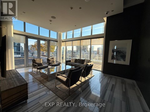 A living room with a view of the city through large windows.